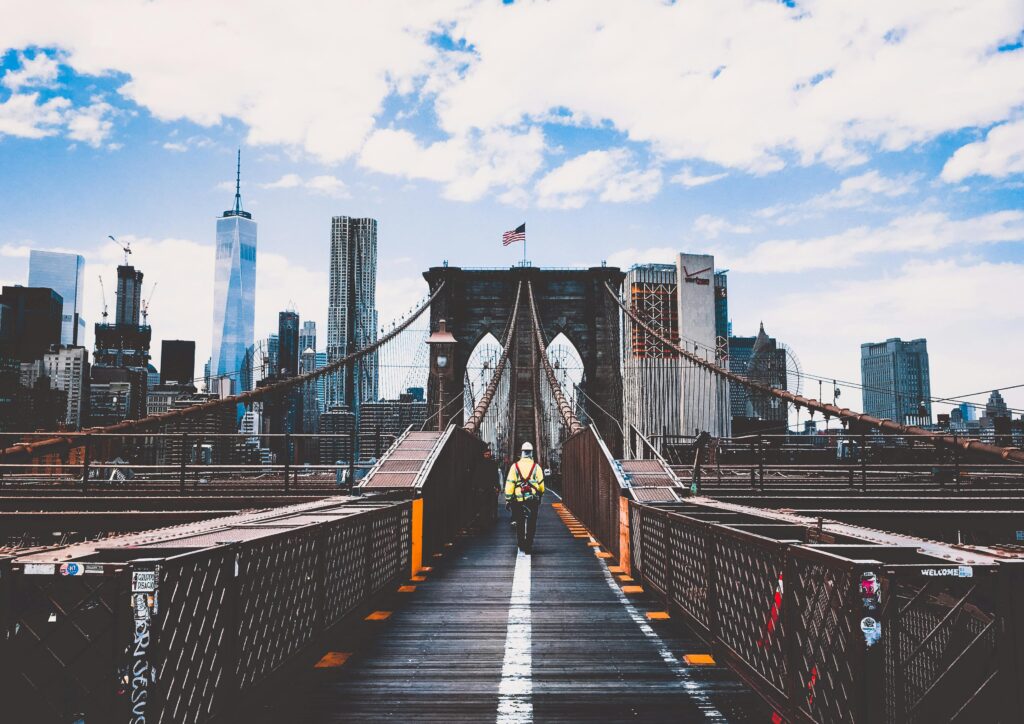 pexels-photo-450597-450597 Iconic Brooklyn Bridge view with New York City skyline and construction worker.