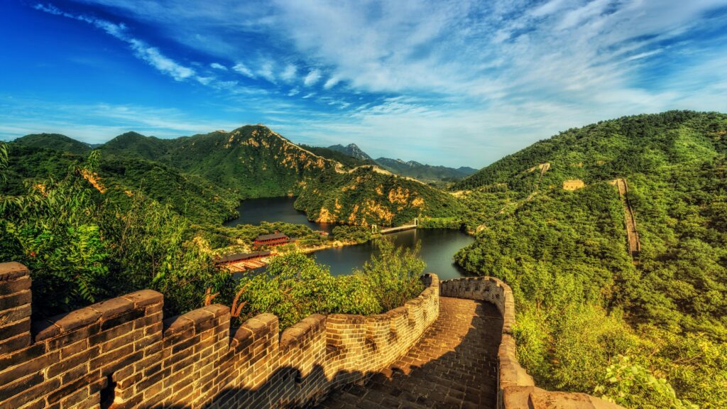 pexels-photo-1423580-1423580 Breathtaking landscape of the Great Wall of China surrounded by lush green hills and vibrant skies.