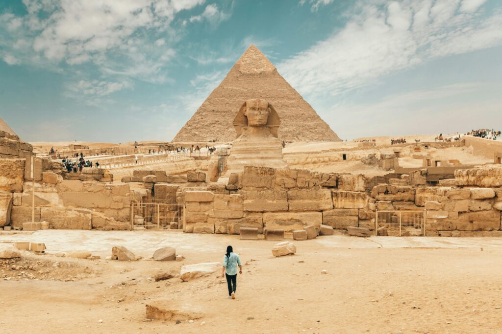 pexels-photo-4356144-4356144 Back view of unrecognizable man walking towards ancient monument Great Sphinx of Giza