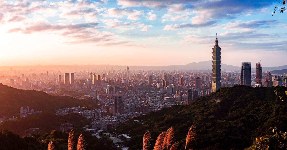 Stunning panorama of Taipei skyline including Taipei 101 viewed from Elephant Mountain under a vibrant sunset sky.