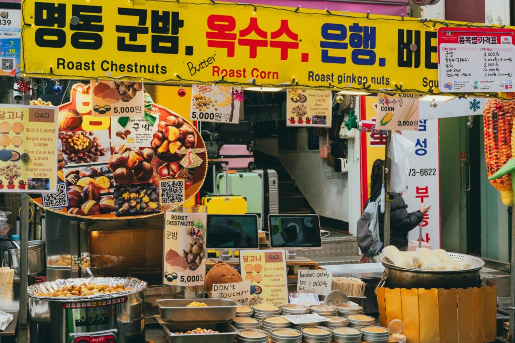pexels-photo-32014932-32014932 Lively street market stall selling roast chestnuts and corn in Seoul, South Korea, showcasing Korean street food culture.