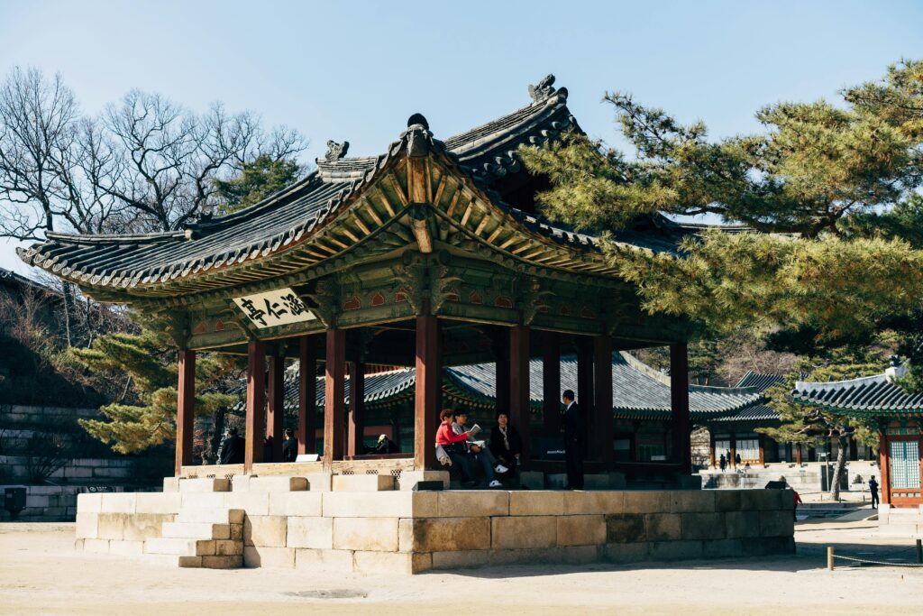 pexels-photo-4840730-4840730 A serene view of visitors at a traditional Korean pavilion in Gyeongbokgung Palace, Seoul.