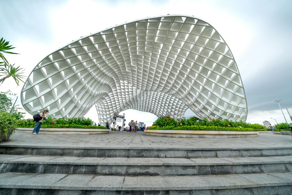 pexels-photo-14021725-14021725 Photo of the iconic Apec Park landmark in Da Nang, Vietnam, featuring tourists and a cloudy sky.