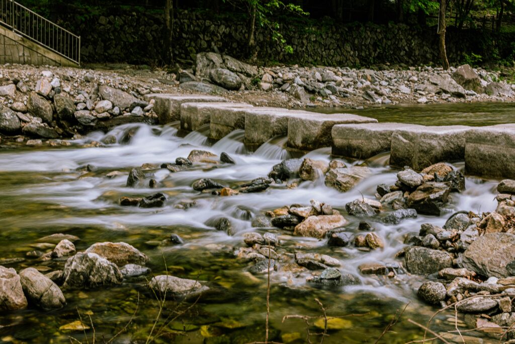 pexels-photo-33735144-33735144 A peaceful stone bridge over a flowing river in Gyeonggi-do, highlighting natural beauty and tranquility.